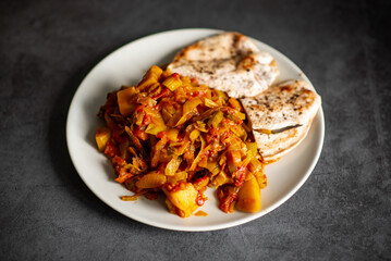 Grilled chicken with sauteed vegetables on white plate.