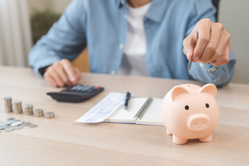 Saving money wealth concept, asian young business man hand putting coin into piggy for saving cost,...