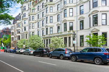 Elegant classical rowhouses and blooming trees along Commonwealth Avenue in Boston, Massachusetts, USA
