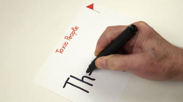 Person writes by hand The Fibber on a sheet of paper.  Preparation to the psychotherapy training on the topic of Toxic people