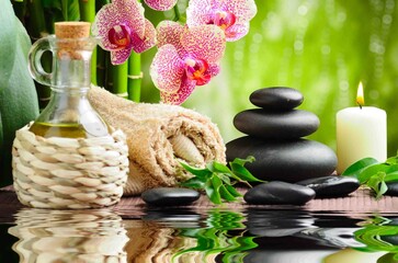 Tranquil Spa Still Life: This photo presents a serene spa scene with lush orchids, bamboo, and...