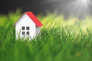 Miniature House Model in Lush Green Grass Symbolizing Dream Home and Sustainable Living with Natural Sunlight
