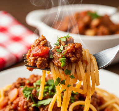 Delicious spaghetti with meat sauce garnished with fresh herbs and vegetables served in a cozy dining setting