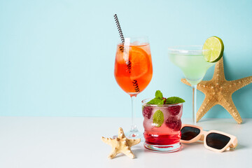 Margarita, Aperol Spritz and strawberry mojito at blue background.