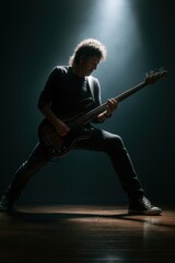 Fototapeta premium Silhouette of musician performing on stage during classic rock concert
