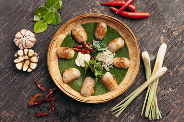 Grilled Sausages with Herbs and Spices on Rustic Wooden Background