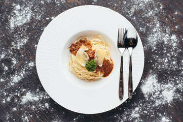 Overhead View of a Delicious Spaghetti Dish with Meat Sauce and Parmesan Cheese
