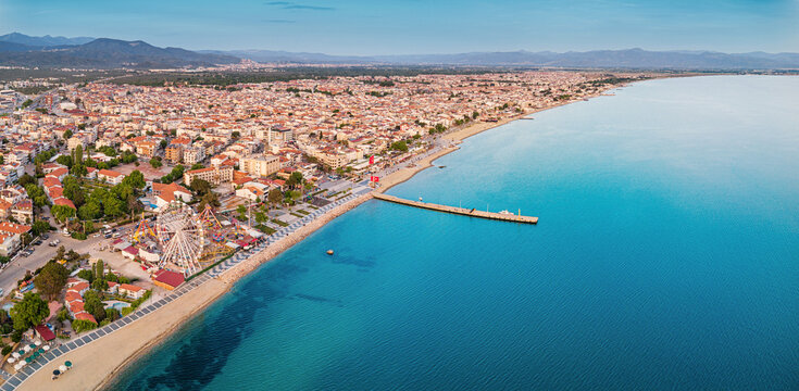 Panoramic view of Akcay, Turkiye coastline, featuring hotels, beaches, and the inviting turquoise waters of the Aegean Sea, a perfect summer getaway
