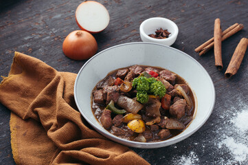 Savory Beef Stew with Aromatic Spices in Rustic Bowl