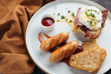 Savory Breakfast Plate Eggs Benedict with Sausages and Hash Browns