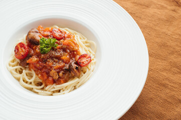 Spaghetti with Tomato Sauce and Parsley on a White Plate