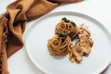 Closeup of Gourmet Spaghetti Dish with Grilled Chicken and Peppercorns