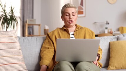 Smiling lady talking using laptop computer enjoying online virtual chat video call with friends or family in distance e chat virtual meeting, waving bye, using pad computer sitting on sofa at home. - Powered by Adobe