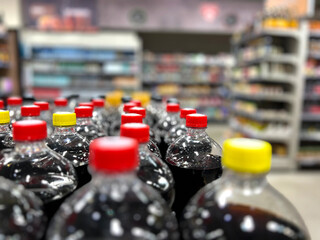 A row of soda bottles with red and yellow caps