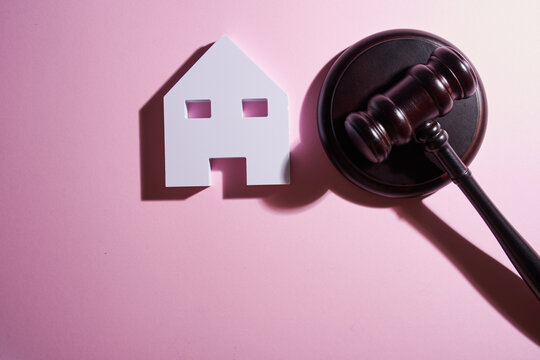 model house and gavel, real estate law and house auction.