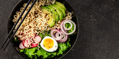 Vegetarian noodle bowl avocado, noodles, egg, vegetables tasty snack fresh delicious gourmet food...