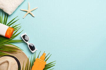 Beach cloth and accessories with sea shells on blue background.
