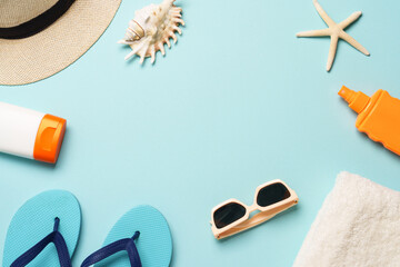Beach cloth and accessories with sea shells on blue background.