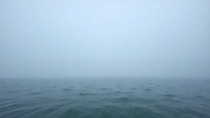 Serene mist over calm waters at dawn