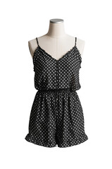 Chic Black and White Polka Dot Romper Displayed on Mannequin Against Black Backdrop