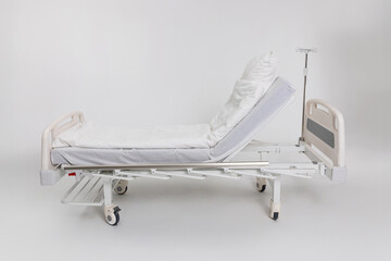 An Adjustable Hospital Bed featuring fresh White Linens to enhance Patient Comfort and care