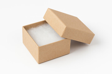 Open kraft jewelry box with white fiber padding insert, lid resting at an angle, isolated on clean white background for product presentation
