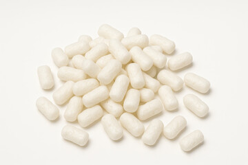 Eco-friendly biodegradable white packing peanuts scattered on a clean white background for shipping and packaging concepts