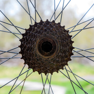 The hub and spokes on a bicycle wheel. Wheel is not on a bike. Closeup view with bright background.