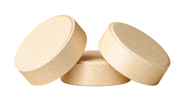Three round beige supplements arranged with overlap on transparent background