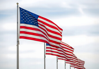 Row of American flags waving against a cloudy sky united states