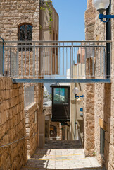  A narrow alley in the old city of Jaffa, Israel, with traditional stone buildings and...