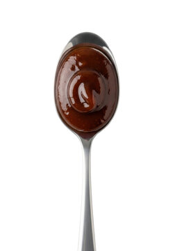 Polished silver tablespoon with a rich, glossy, thick dark brown oyster sauce, perfectly centered on a seamless transparent background, high-contrast studio close-up, culinary ingredient concept
