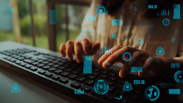 A closeup image of hands typing on a keyboard with overlaying data visualization elements. This scene captures the essence of technology and innovation in modern workspaces. Xenic