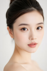 Obraz premium Female Asian Model with Short Hair - Young Beautiful Woman with Hair Bun - Studio Portrait of Asian Beauty for Fashion, Cosmetic, Skincare - Posing on White Background - Smooth Tied Hair