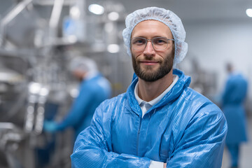 Smiling worker in a sterile environment with advanced machinery