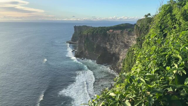 Stunning view at Pura Luhur Uluwatu with ocean giant waves crashing on cliffs, Bali, Indonesia