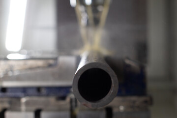 Metal Tube in Industrial CNC Lathe Close-Up with Shallow Depth of field