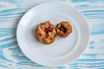 A white plate with two pieces of food on it