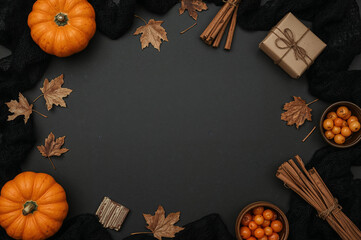 Autumn flat lay with pumpkins dried leaves cinnamon sticks berries gift box and lace on dark matte background