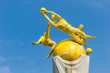 Golden sculpture of soccer players on the Minyuan square in Tianjin, China