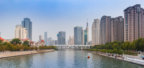 Fototapeta premium Panorama of apartment buildings and offices at the river in Tianjin, China