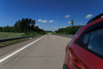 Road view on a summer day. Highways and cars, roadside and white road line markings.