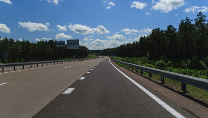 the road on a summer day. Highways, roadside and road line markings.