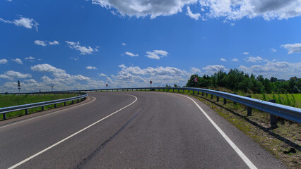 Road view on a summer day. Highways and cars, roadside and white road line markings.