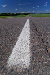 Road view on a summer day. Highways and cars, roadside and white road line markings.