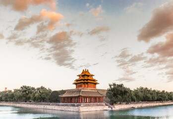 Sunset light over the corner tower at the moat of the Forbidden City in Beijing, China