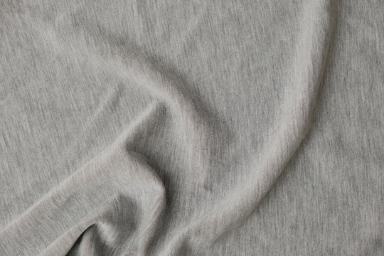 Gray sportswear fabric texture background with soft drapery. Activewear and athletic clothing material made from modal, polyester, and elastane blend