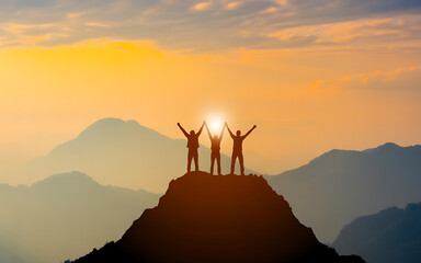 Success teamwork achievement concept with people on mountain peak at sunset