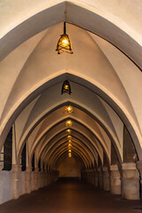 Arched colonnade of the Governor’s Palace with antique lamps at dusk, Rhodes town, Greece