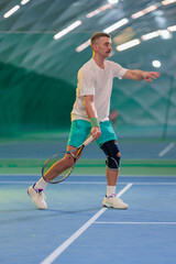 Obraz premium Man playing tennis on a court